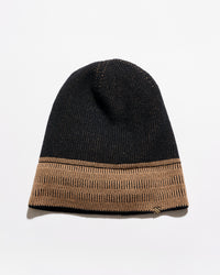 A black knit beanie hat featuring a contrasting tan ribbed cuff, photographed against a clean white background.