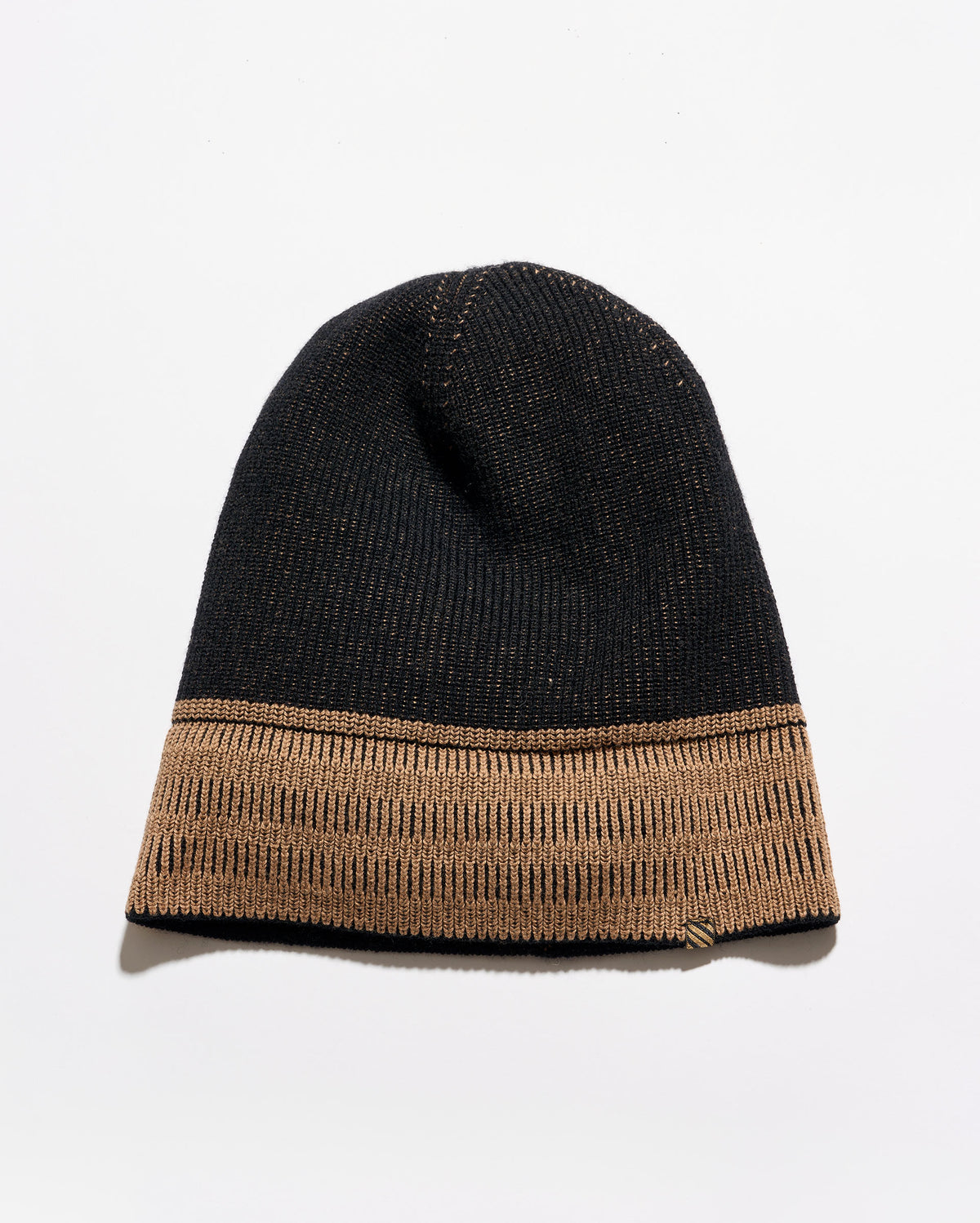 A black knit beanie hat featuring a contrasting tan ribbed cuff, photographed against a clean white background.
