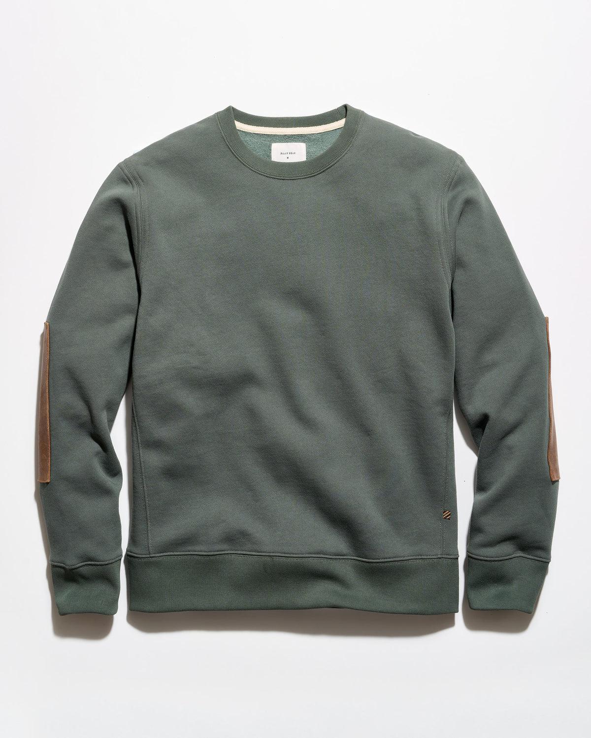 An olive green crewneck sweatshirt with brown leather elbow patches, laid flat against a light gray background.