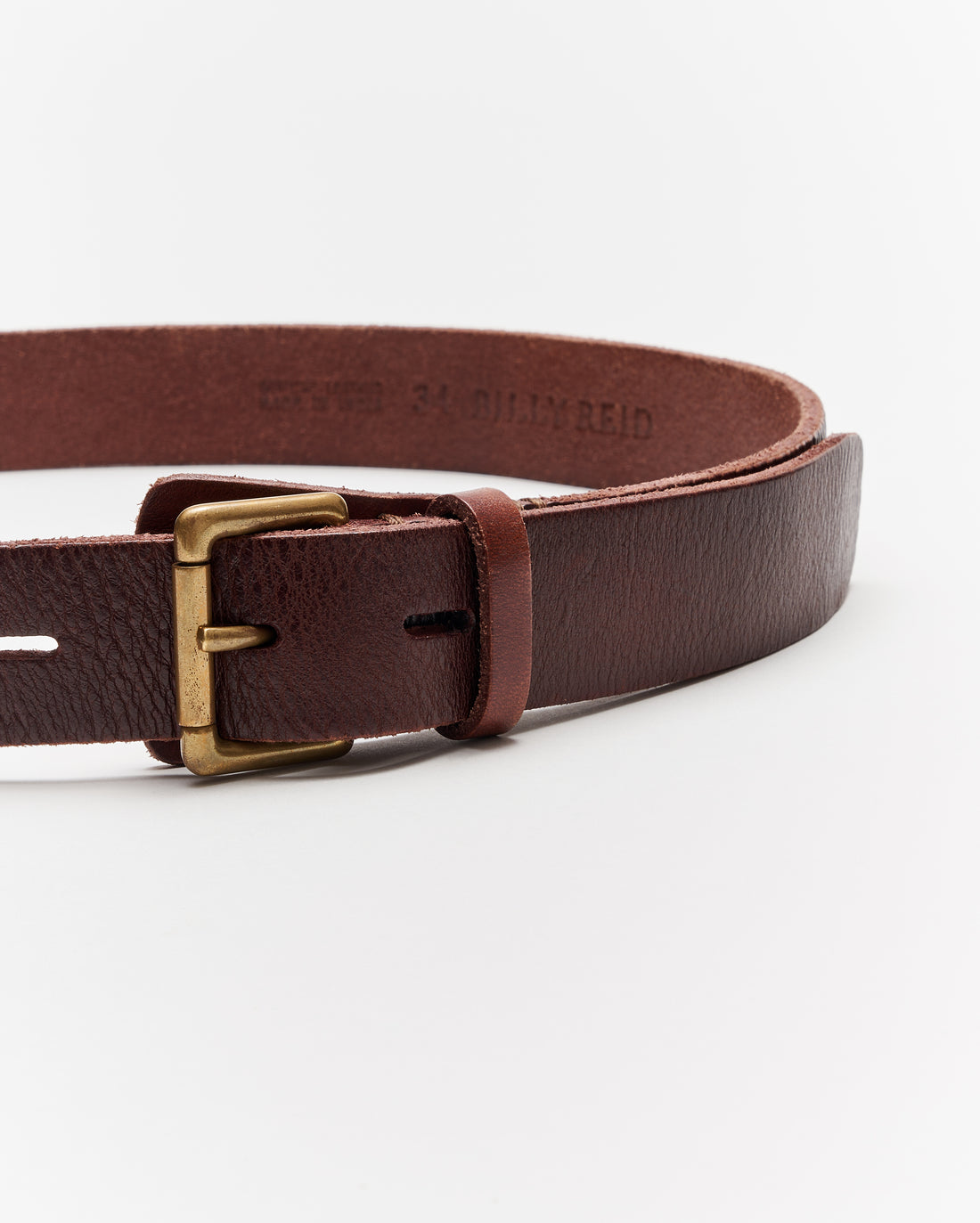 A close-up of a brown leather belt with a brass buckle displayed against a plain white background.