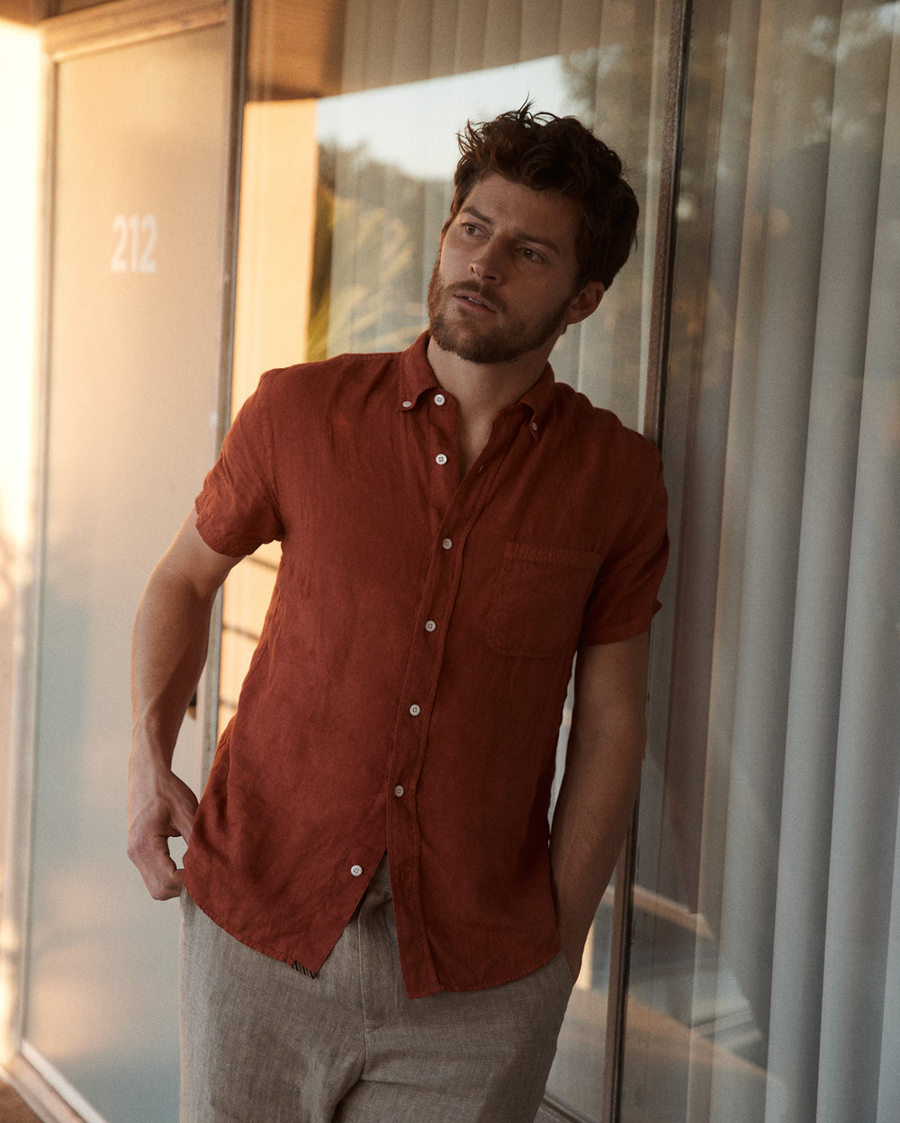 Model wears the Billy Reid Short Sleeve Linen Tuscumbia Shirt Button Down in Brick