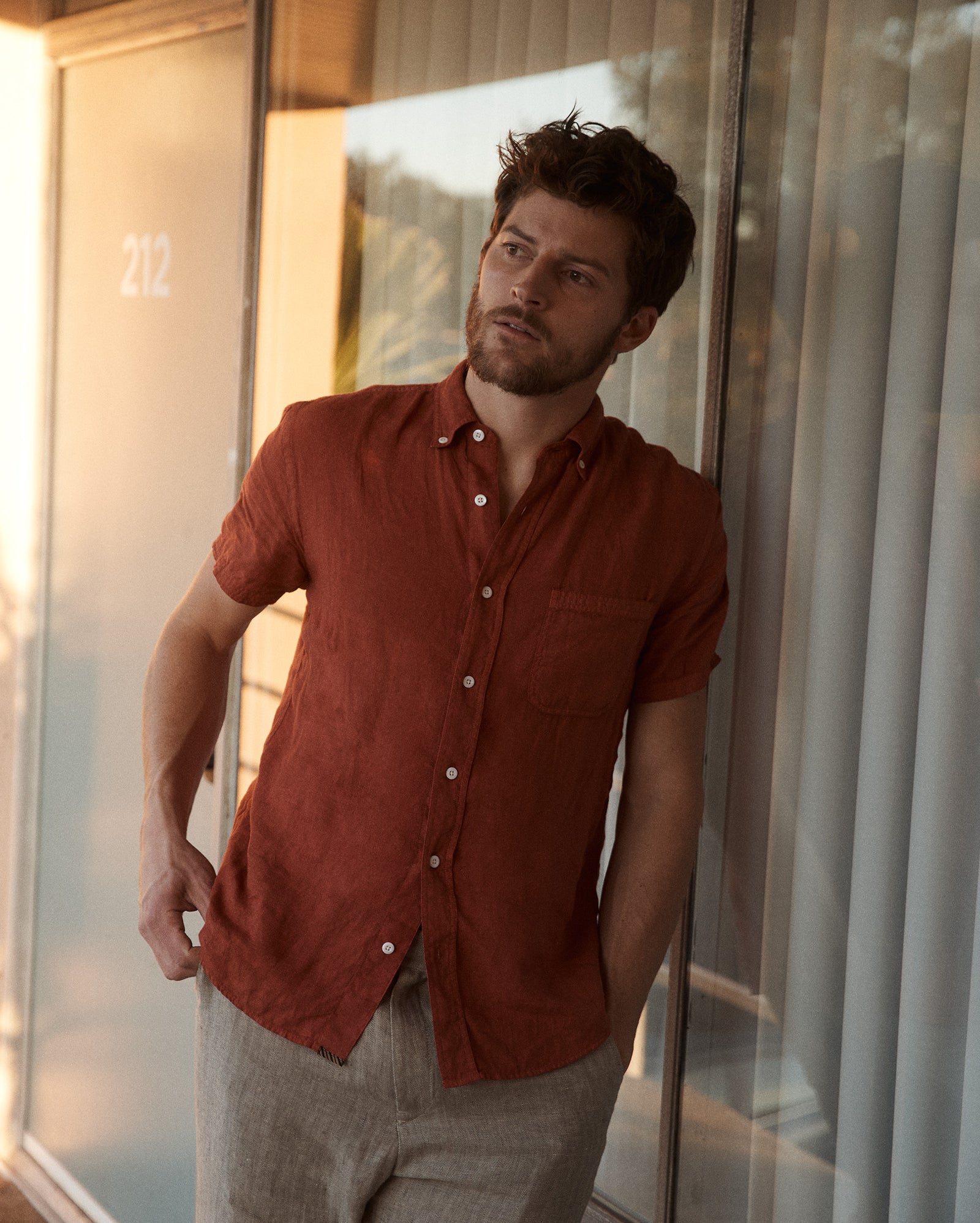 Model wears the Billy Reid Short Sleeve Linen Tuscumbia Shirt Button Down in Brick