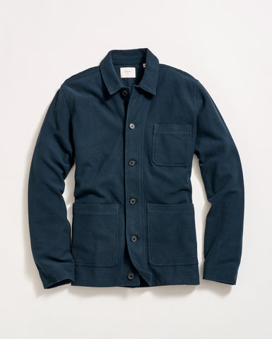 A navy blue button-up jacket with a collar, long sleeves, and three front pockets, laid flat on a white background.