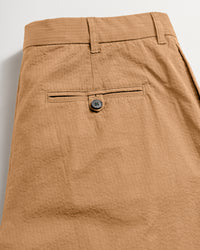 Back of the pant showing the back pocket finsihed with dark horn button closure.