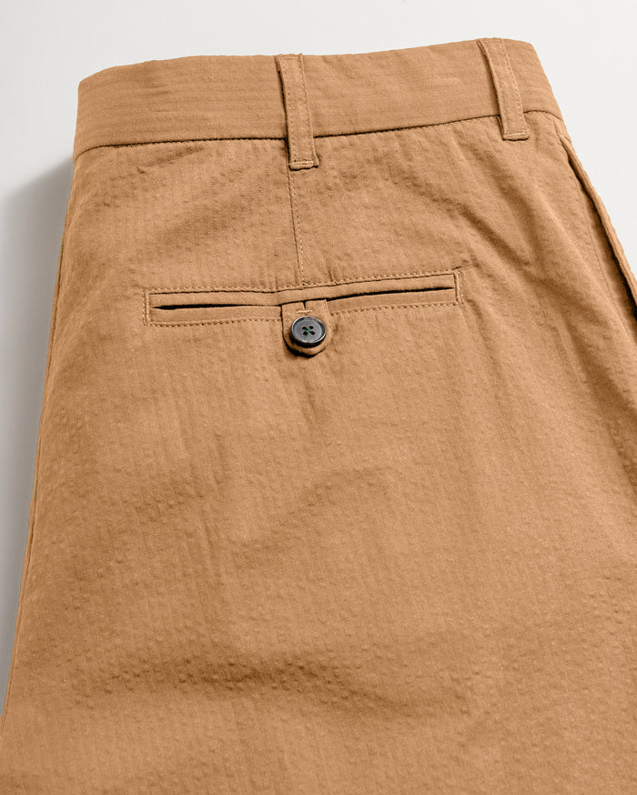 Back of the pant showing the back pocket finsihed with dark horn button closure.
