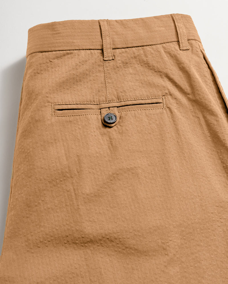 Back of the pant showing the back pocket finsihed with dark horn button closure.