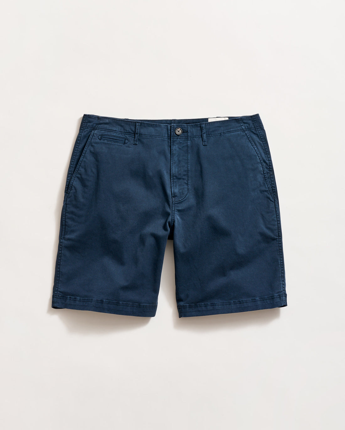 A pair of navy blue chino shorts with side pockets, a small coin pocket on the right, and a button closure, laid flat on a white background.