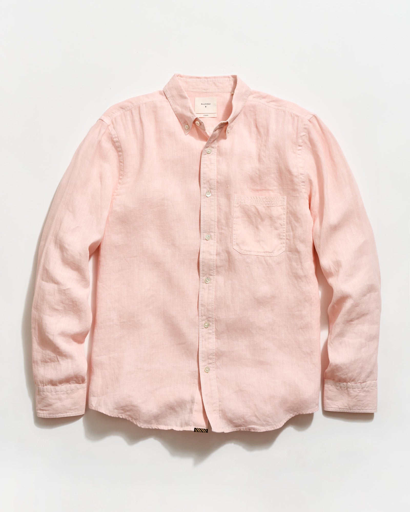 Pink button-up shirt on a light gray background