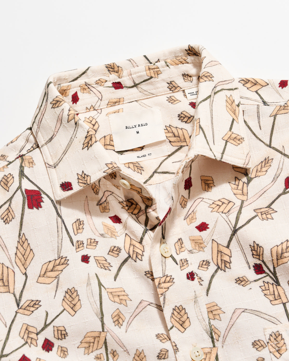 Floral patterned shirt with a visible brand label on a white background