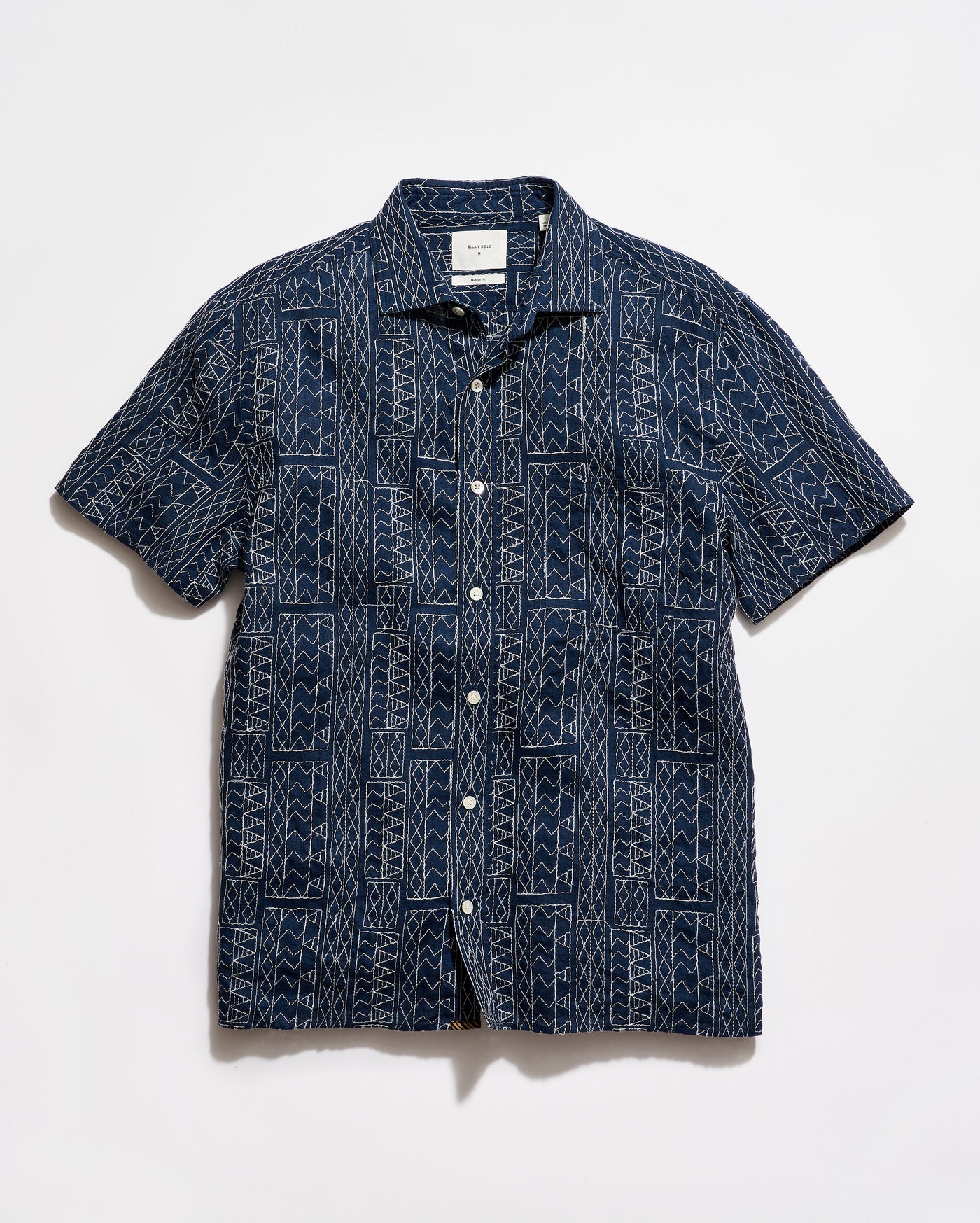 Navy patterned shirt on a white background