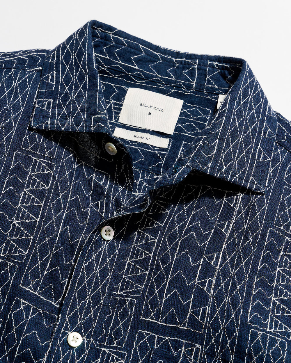 Navy blue shirt with white geometric pattern on a white background