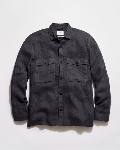 Dark denim shirt with two front pockets on a light gray background