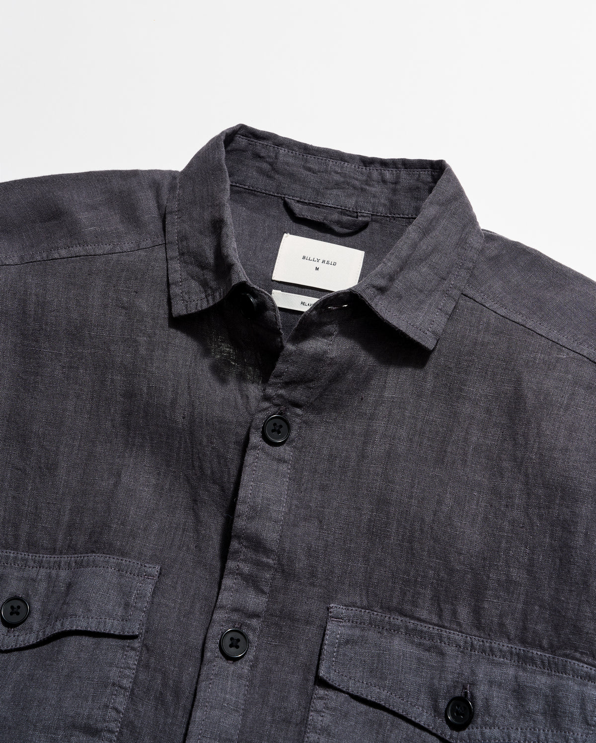 Dark gray shirt with collar and buttons on a light gray background
