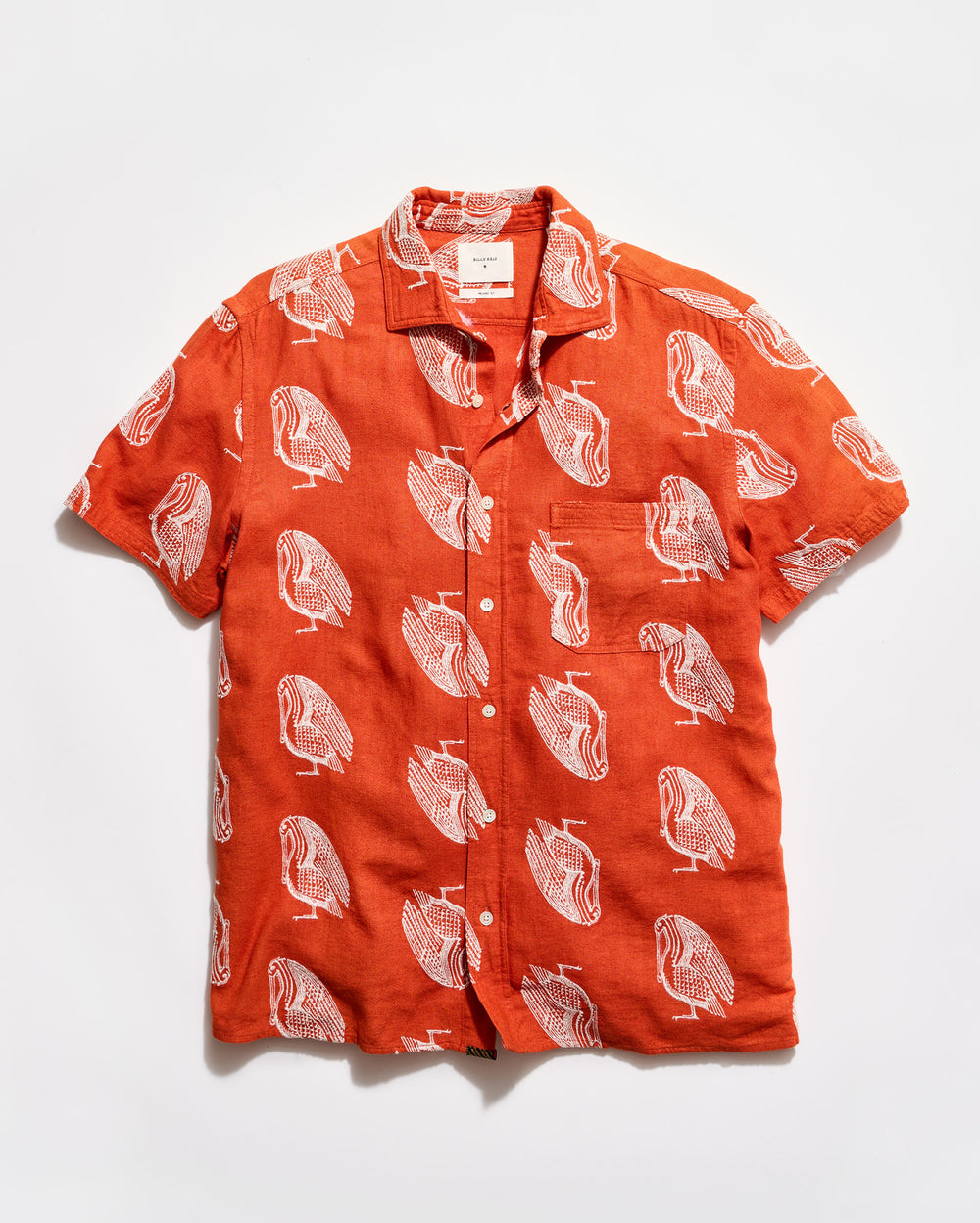 Orange shirt with white bird pattern on a white background