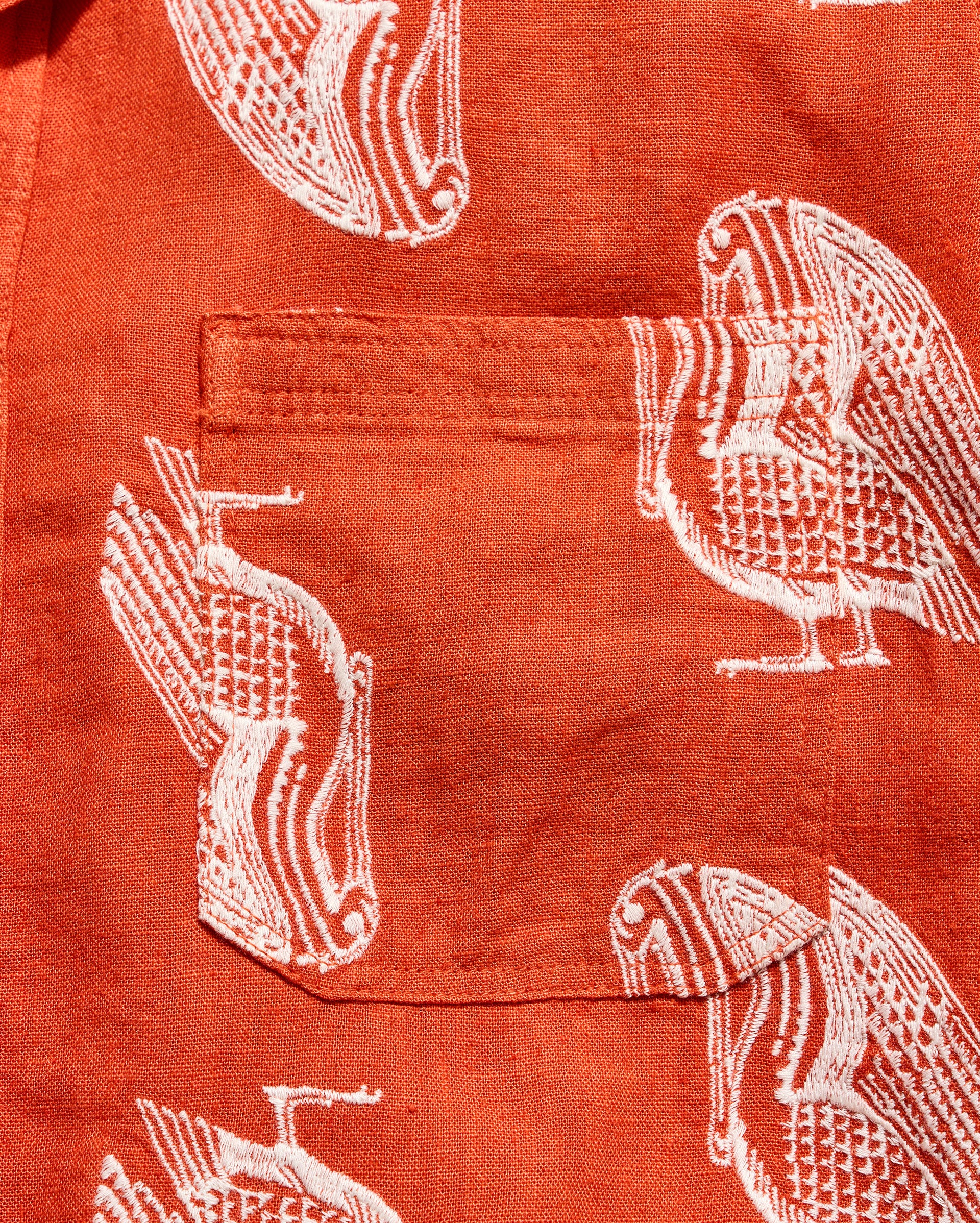 Red shirt with white bird pattern