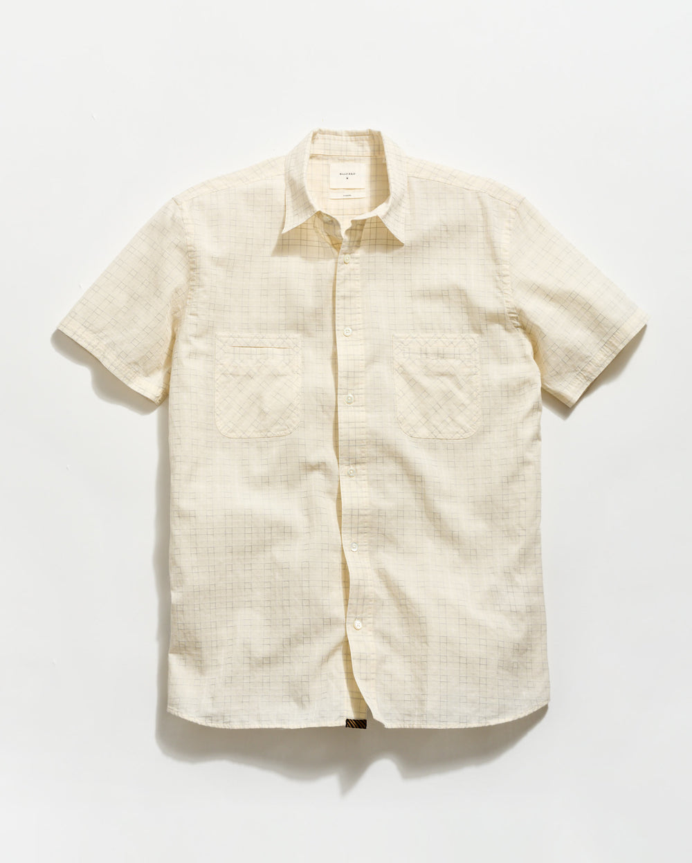 Beige short-sleeve shirt on a white background