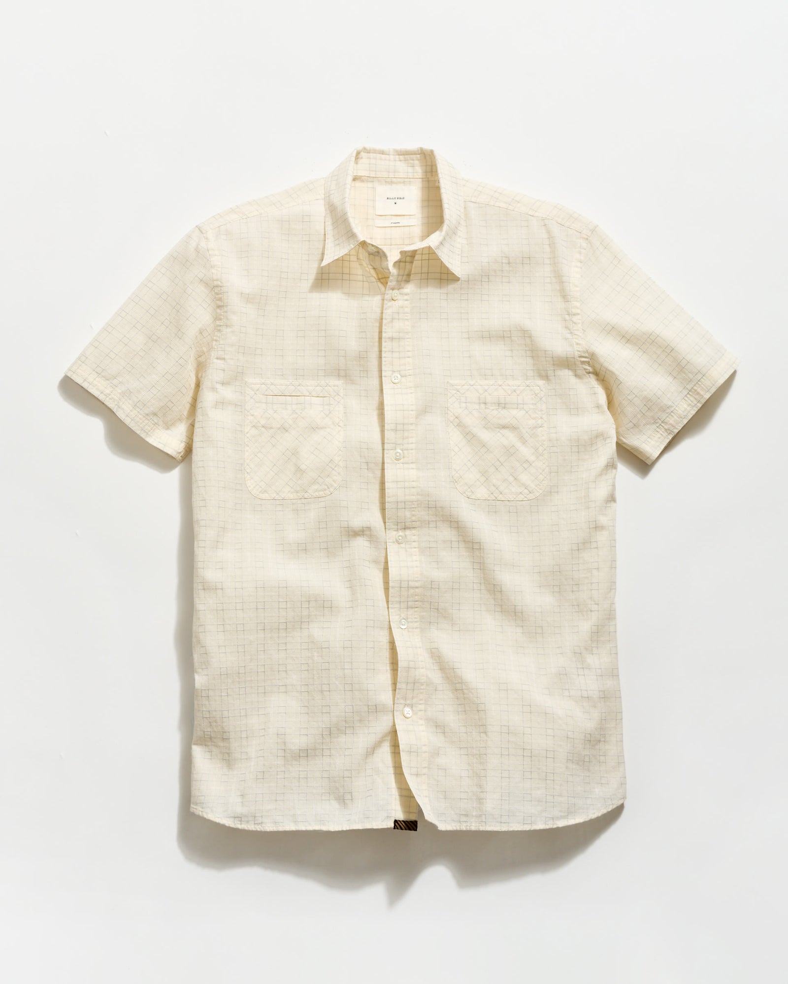 Beige short-sleeve shirt on a white background