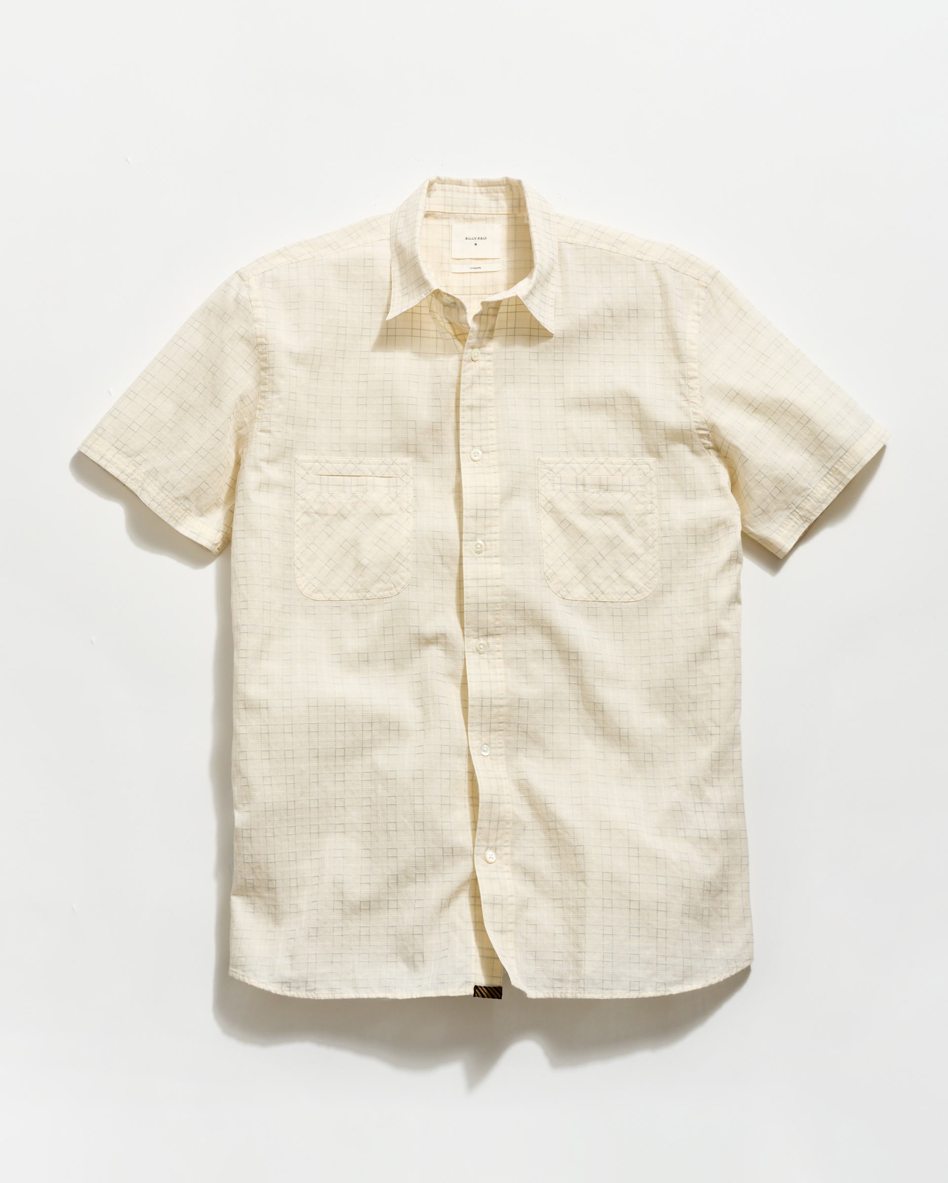 Beige short-sleeve shirt on a white background