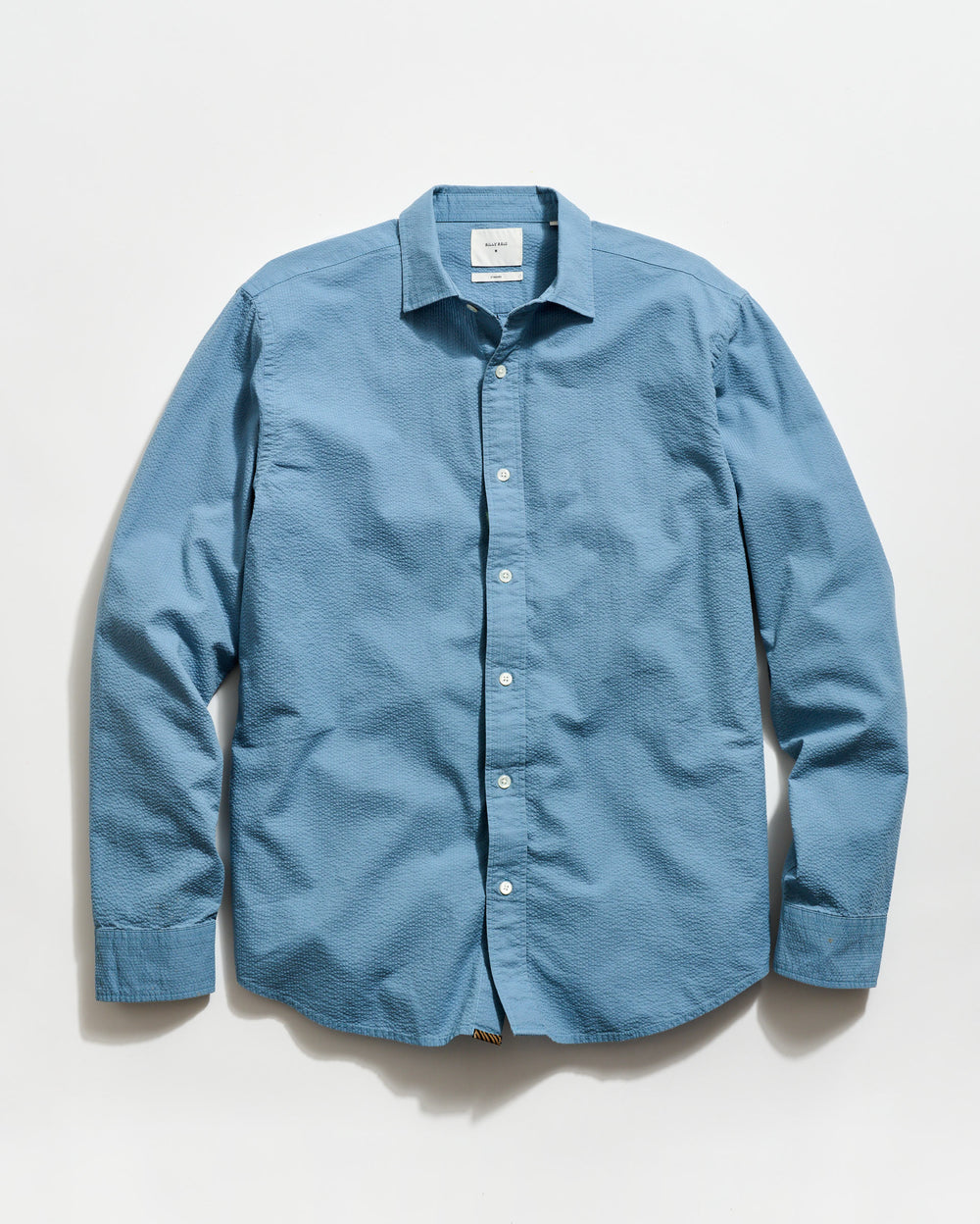 Blue button-up shirt on a light gray background