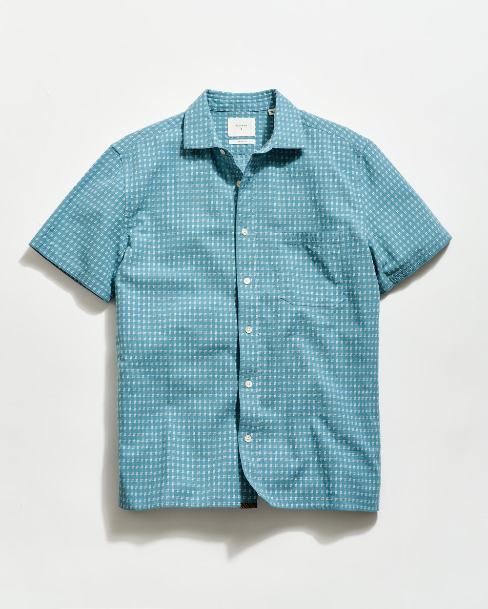 Blue patterned short-sleeve shirt on a light gray background
