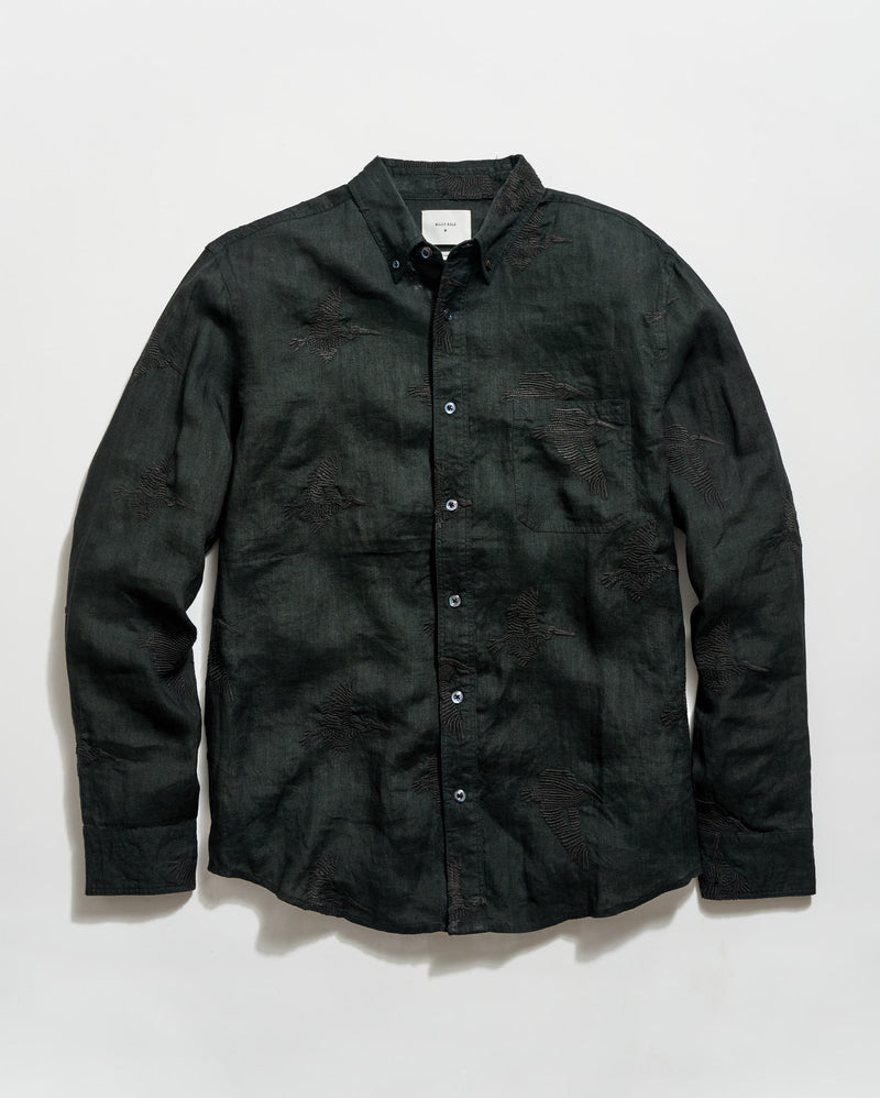 Black button-up shirt on a light gray background