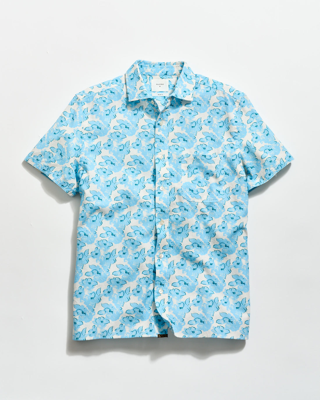 Blue and white patterned shirt on a light gray background