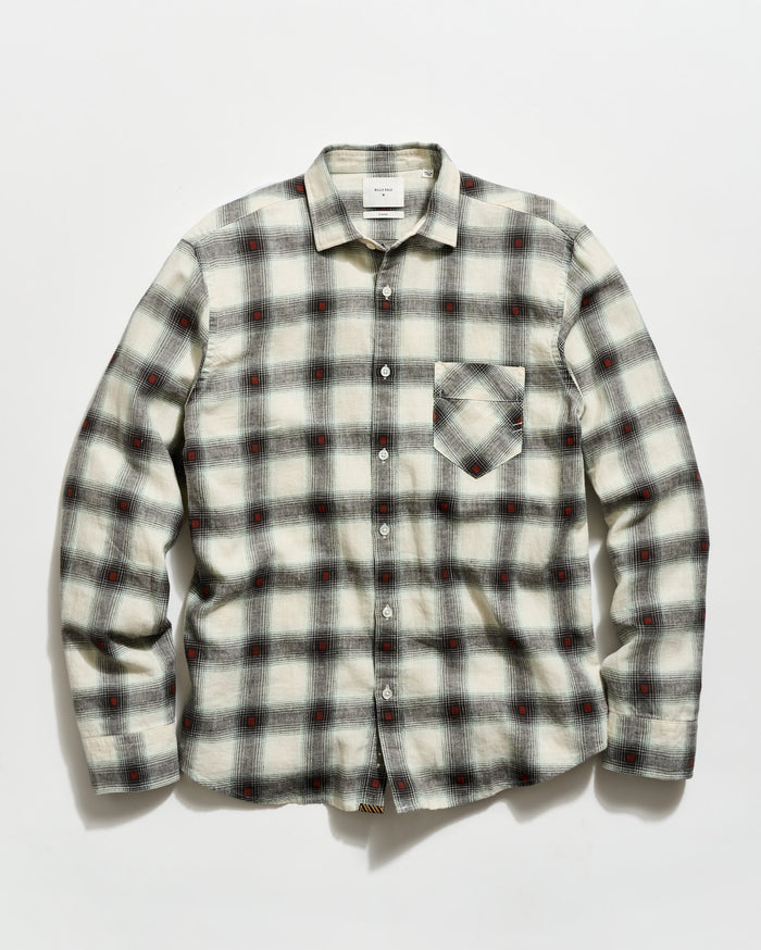 Plaid shirt with a pattern of black, red, and white on a light gray background
