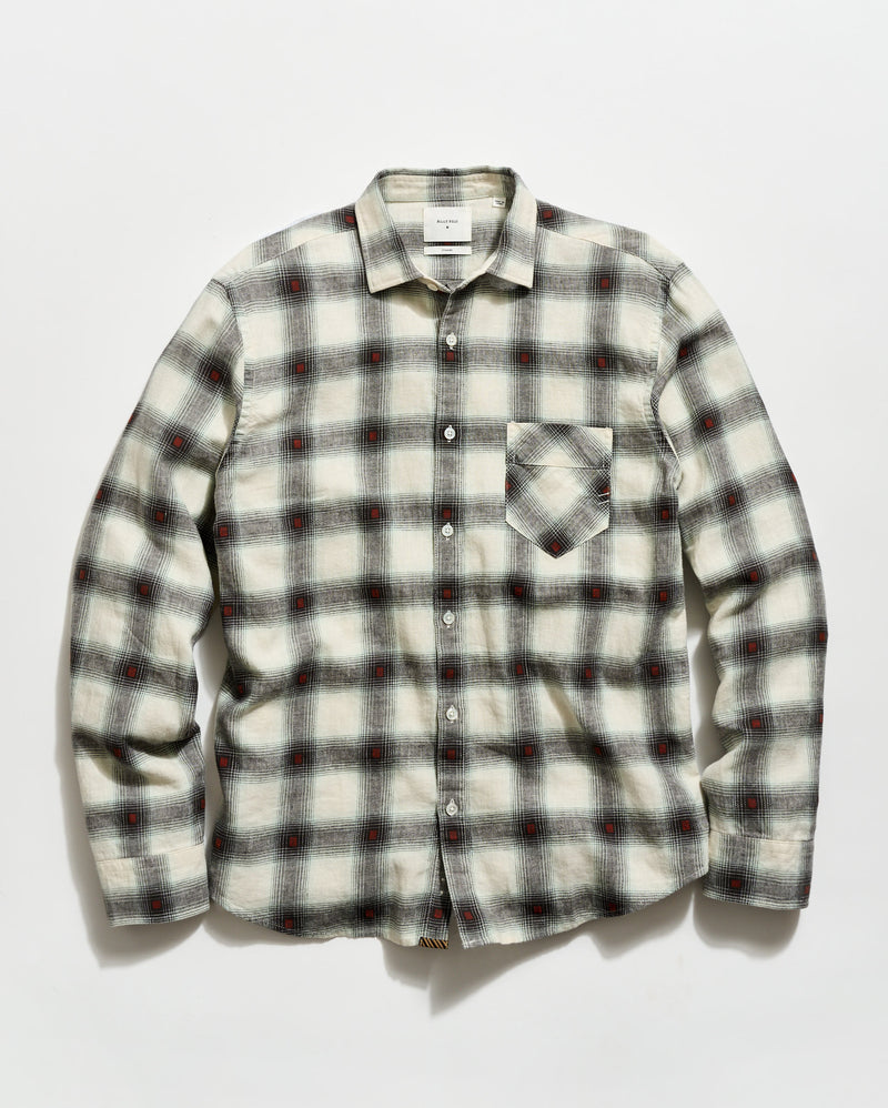 Plaid shirt with a pattern of black, red, and white on a light gray background