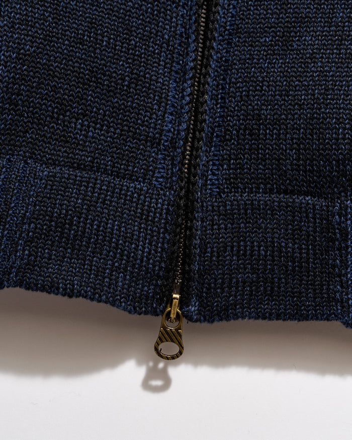 Close-up of a navy blue zipper on a textured fabric background