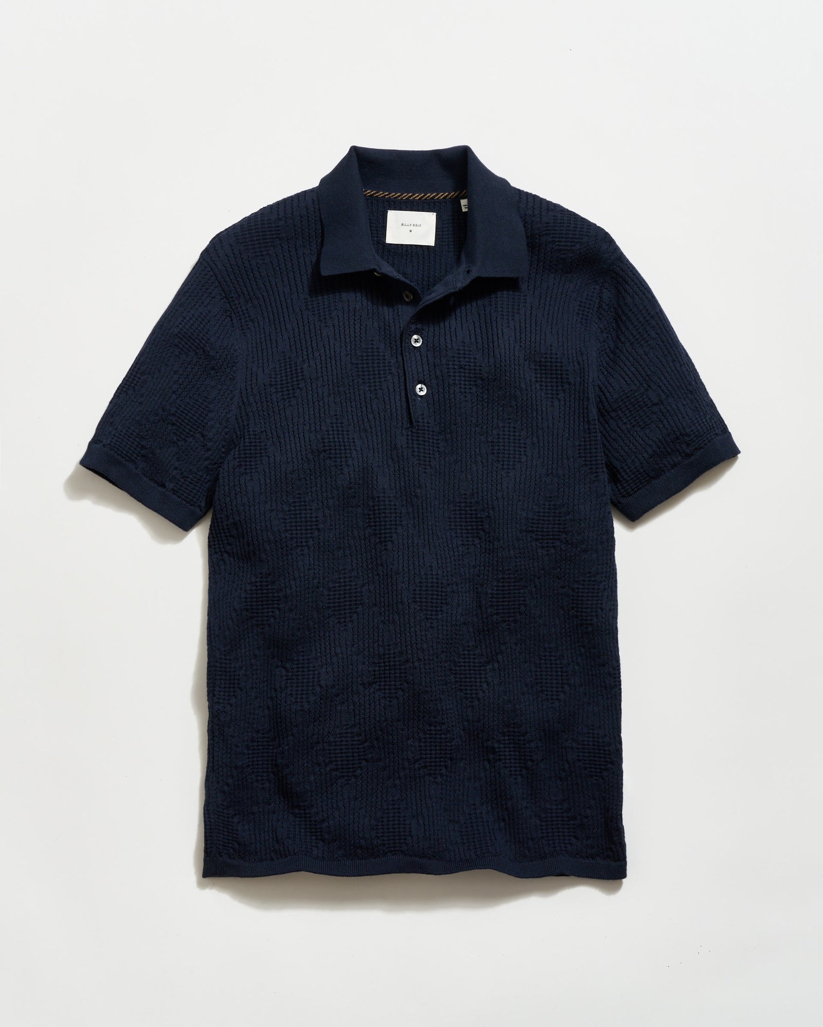 Navy textured polo shirt on a light gray background
