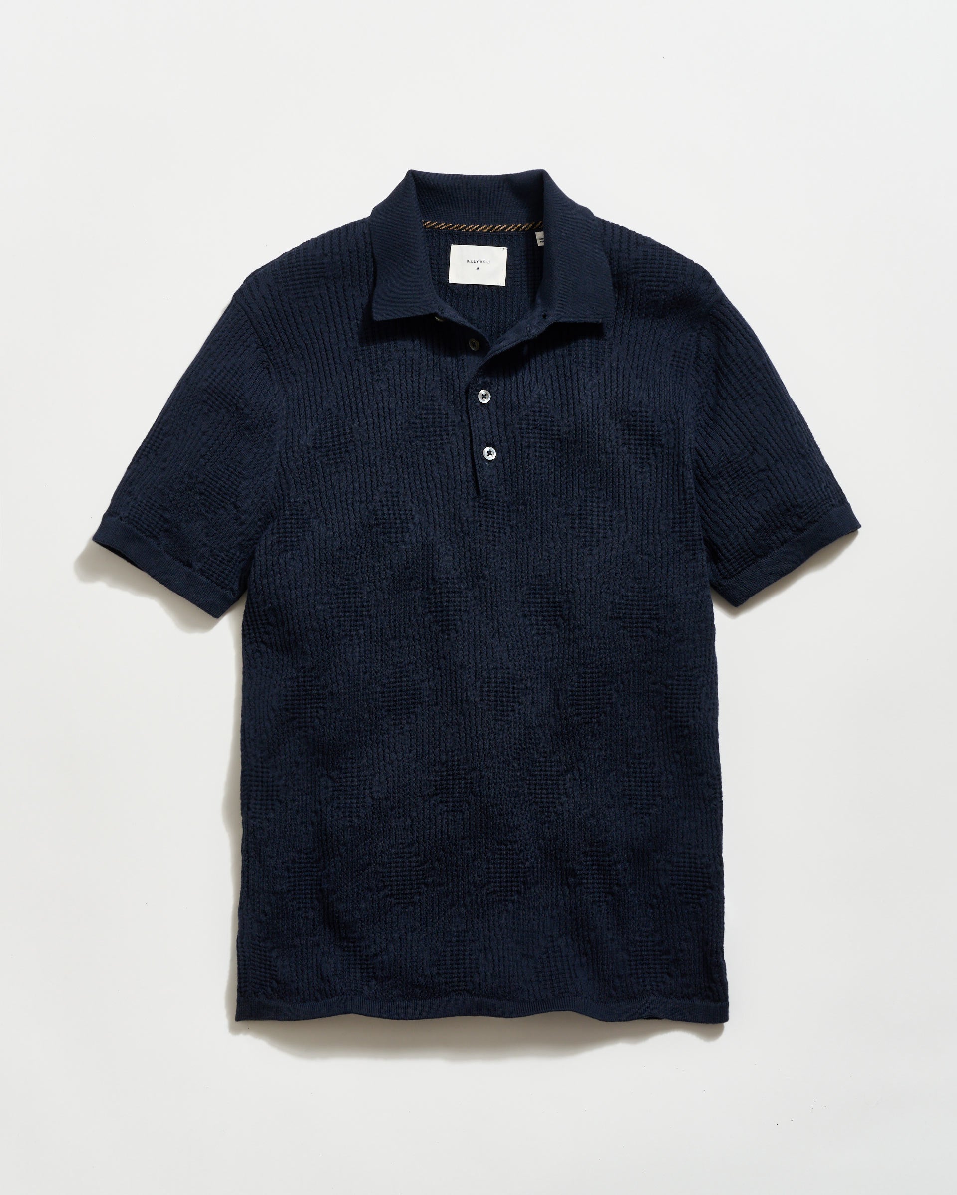 Navy textured polo shirt on a light gray background