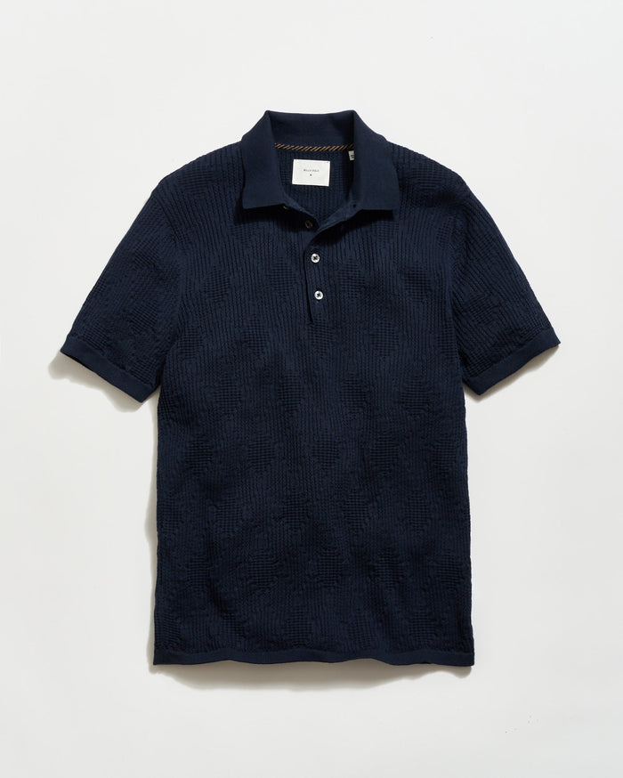 Navy textured polo shirt on a light gray background