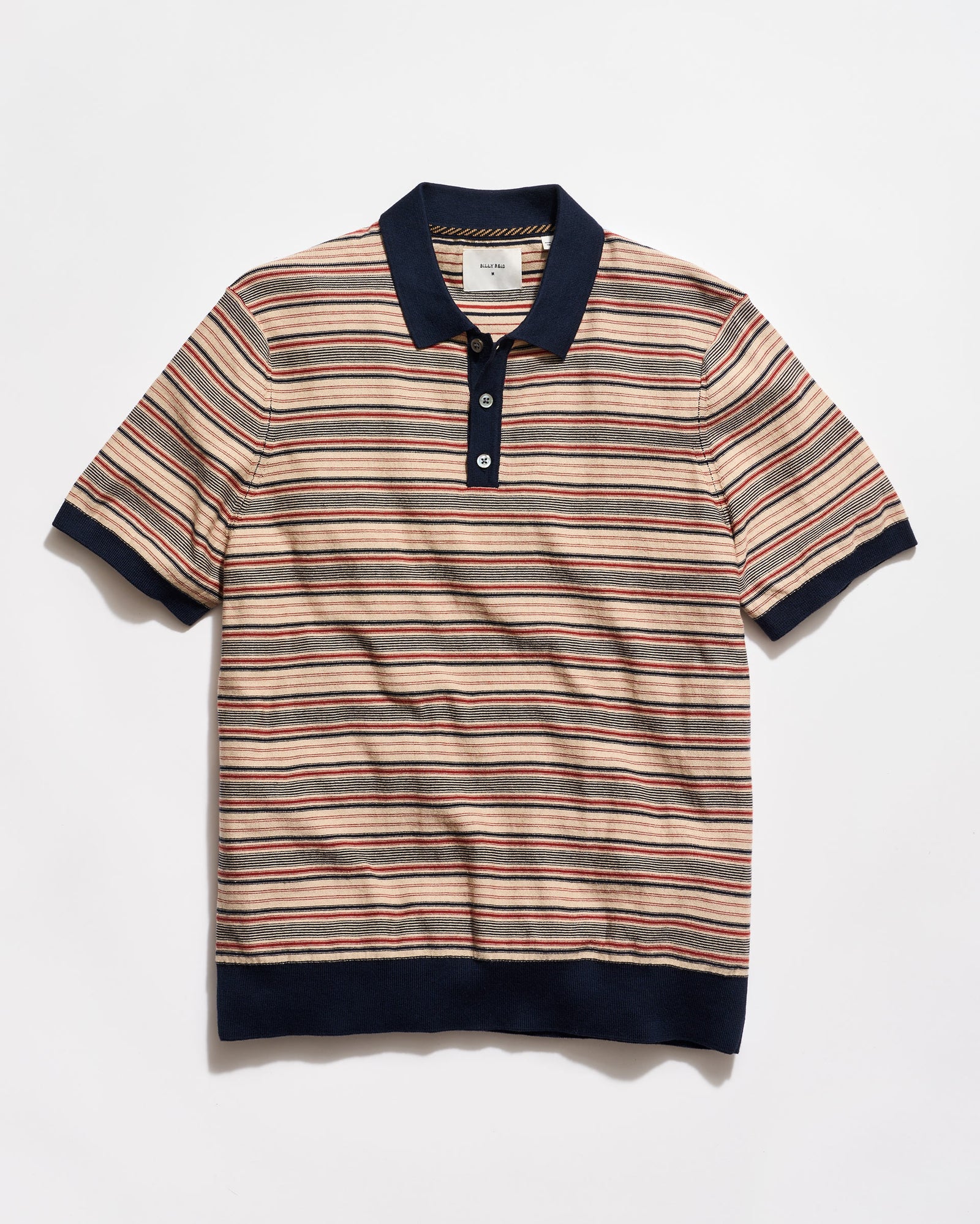 Striped polo shirt with navy accents on a light gray background