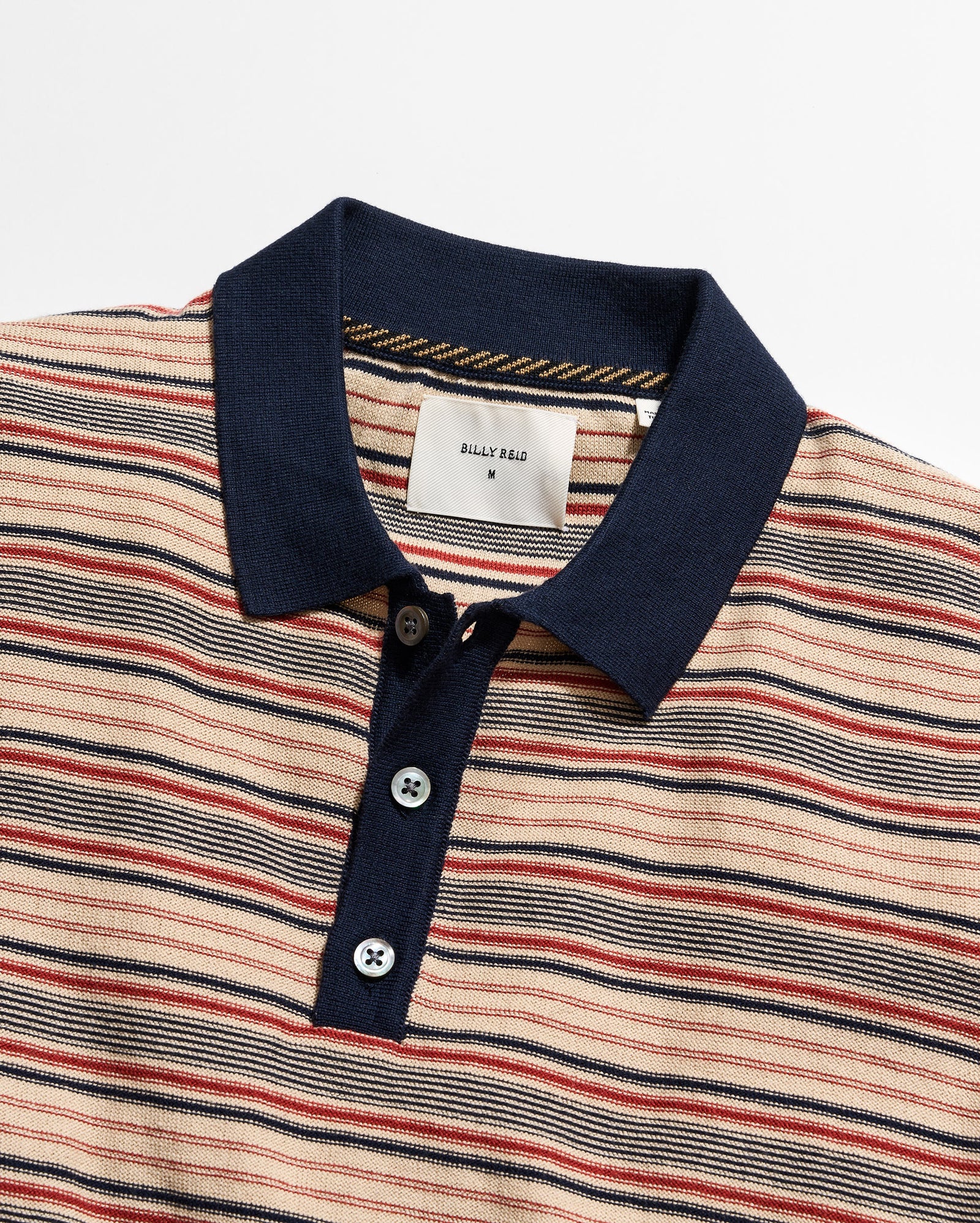 Striped polo shirt with a navy collar on a white background