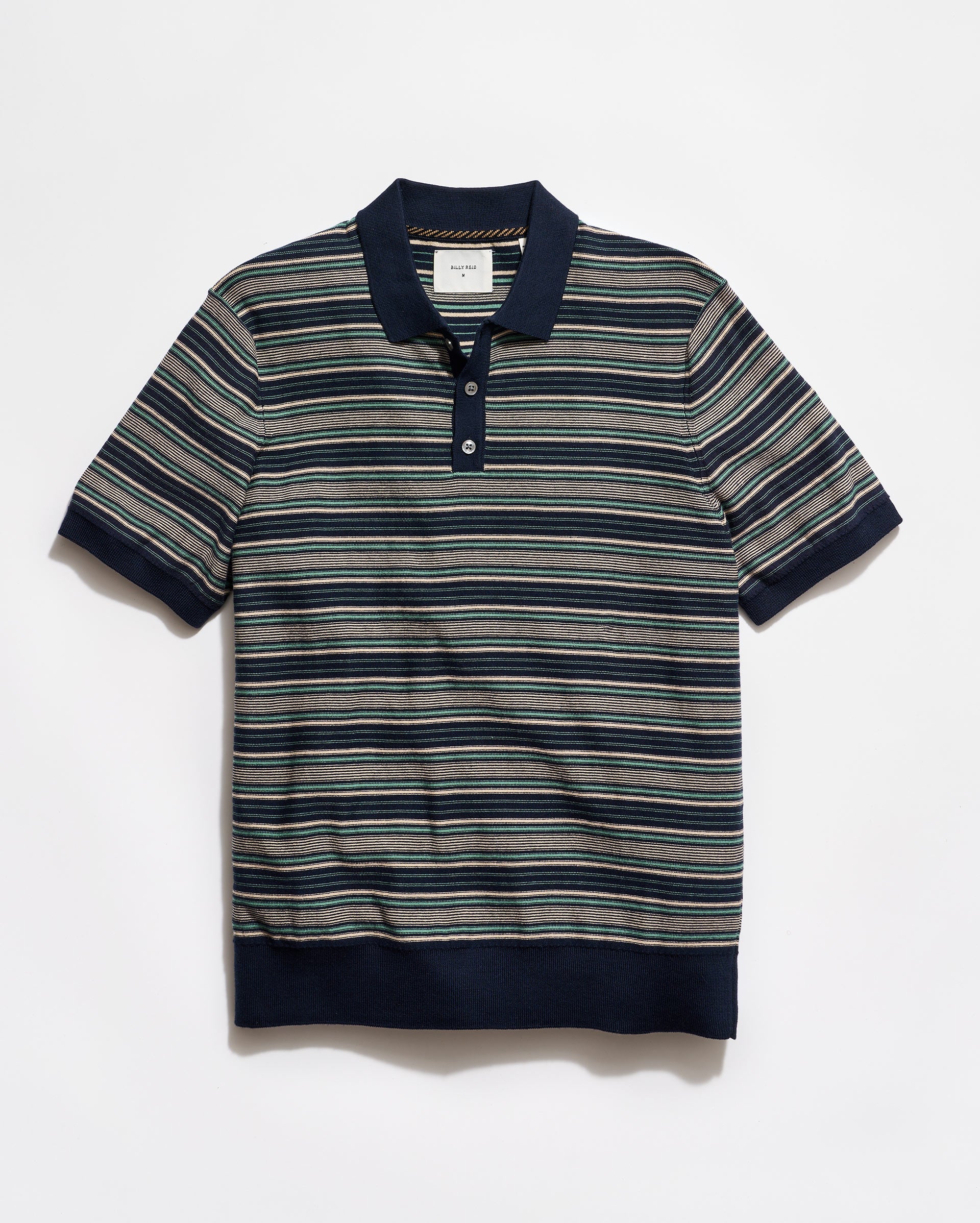 Striped polo shirt with navy collar and trim on a white background
