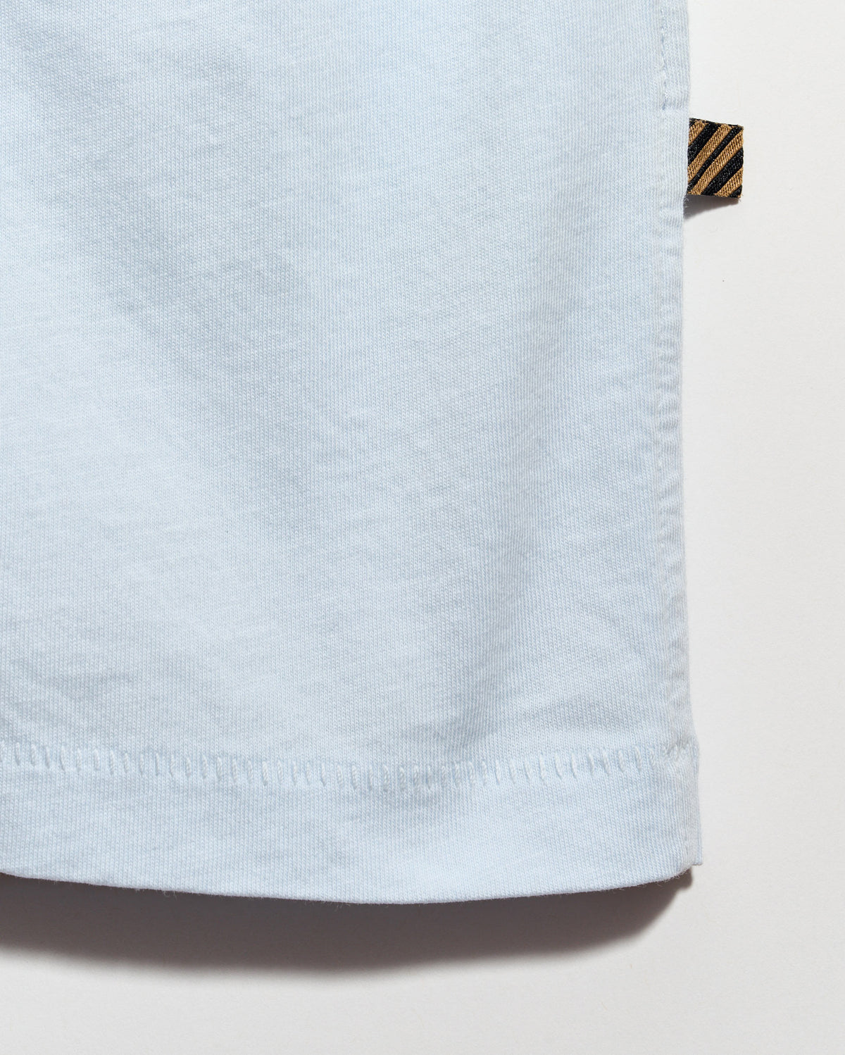 Light blue fabric with a brand label on a white background