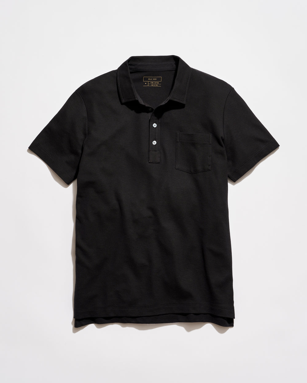 Black polo shirt on a light gray background