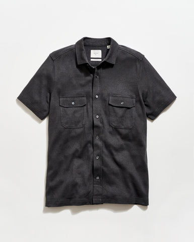 Black short-sleeve shirt with two pockets on a white background