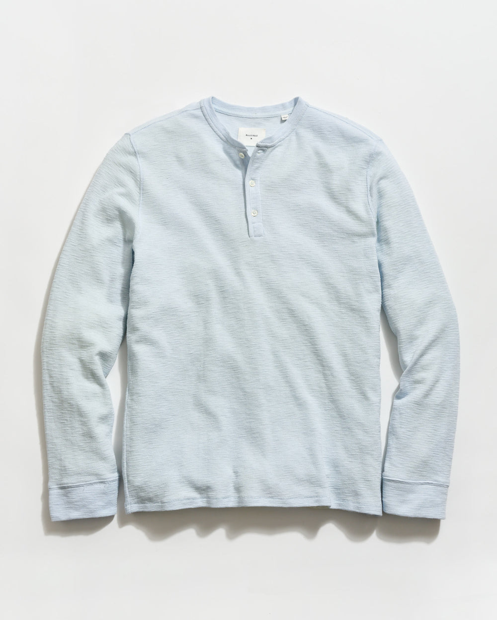 Light blue long-sleeve shirt on a light gray background