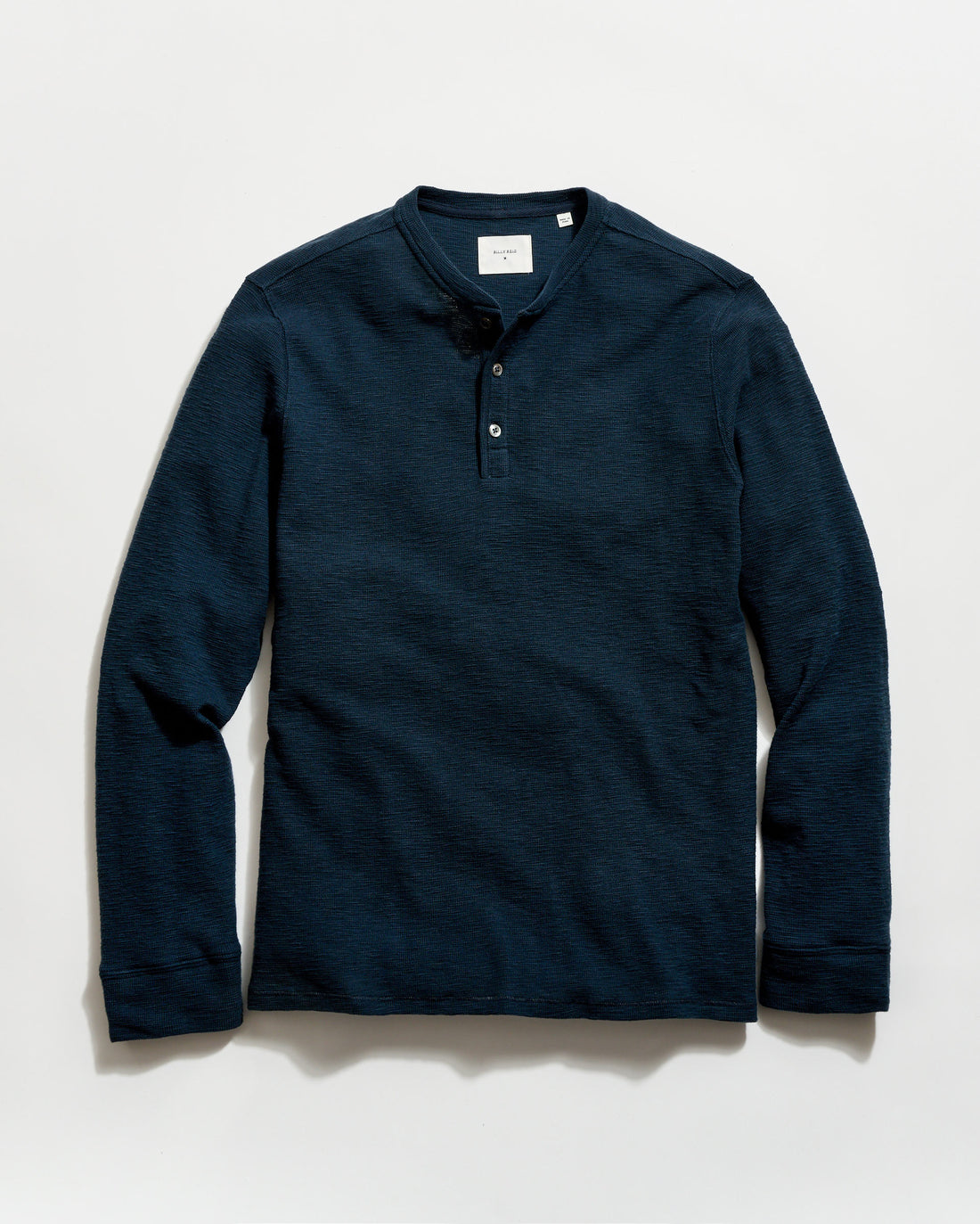 Navy long-sleeve henley shirt on a light gray background