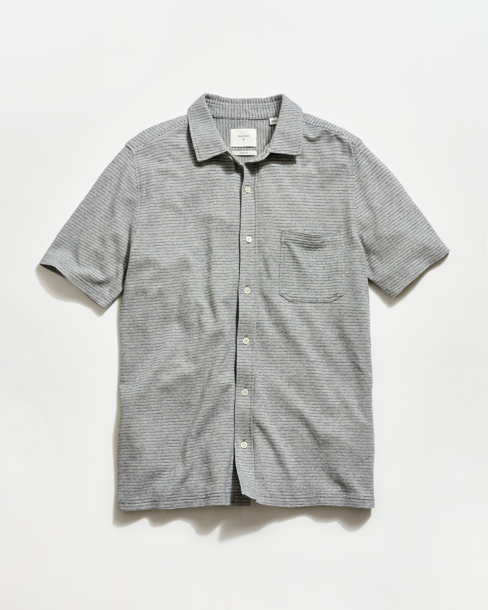 Gray striped short-sleeve shirt on a light gray background