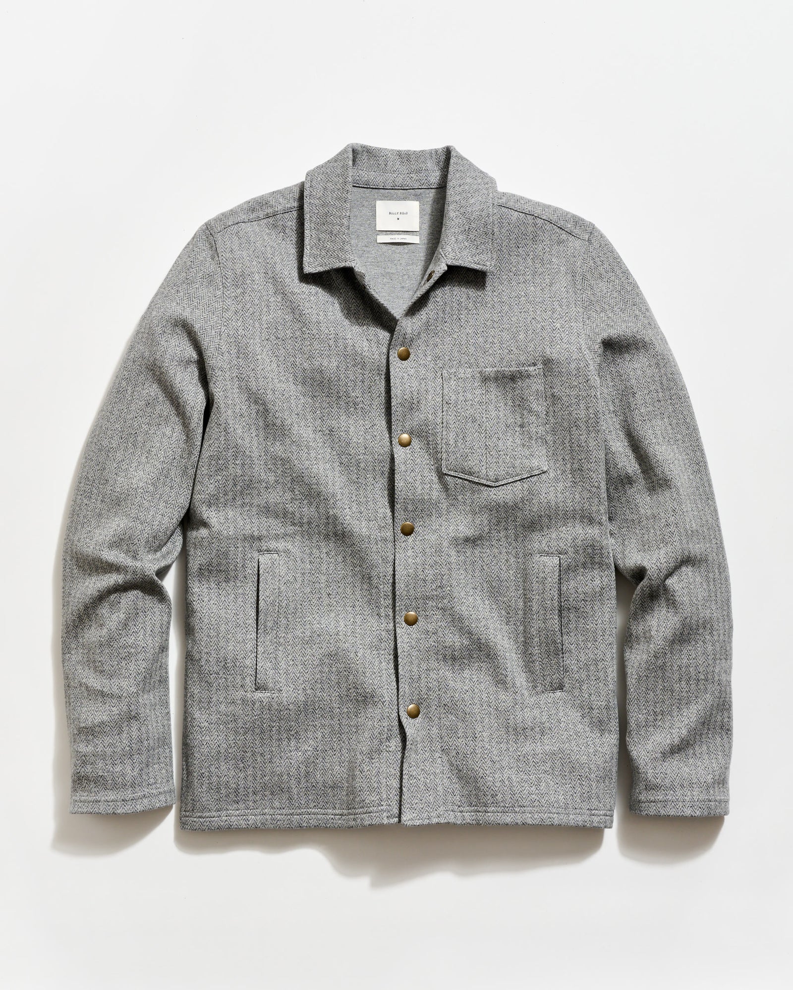 Gray checkered shirt with button details on a white background
