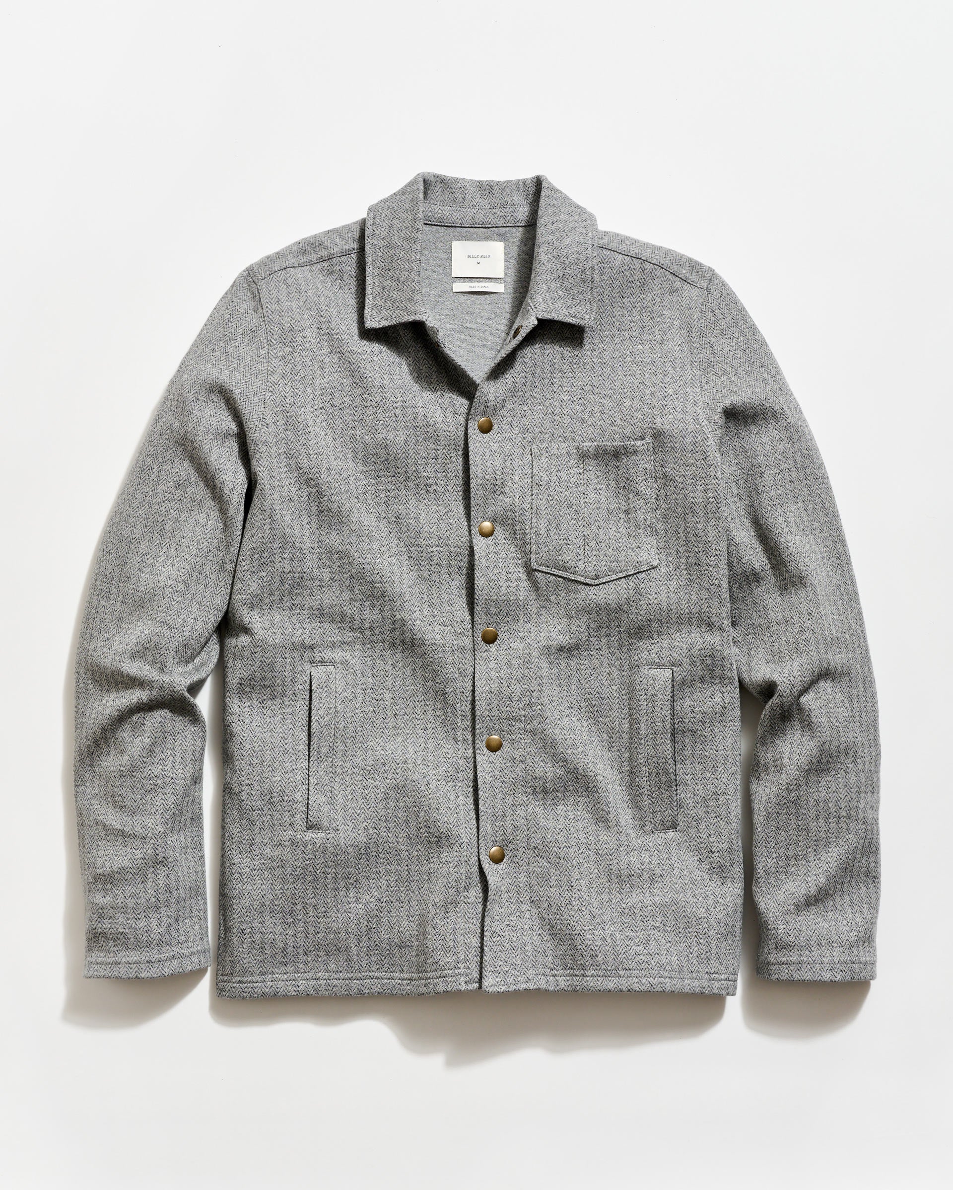 Gray checkered shirt with button details on a white background
