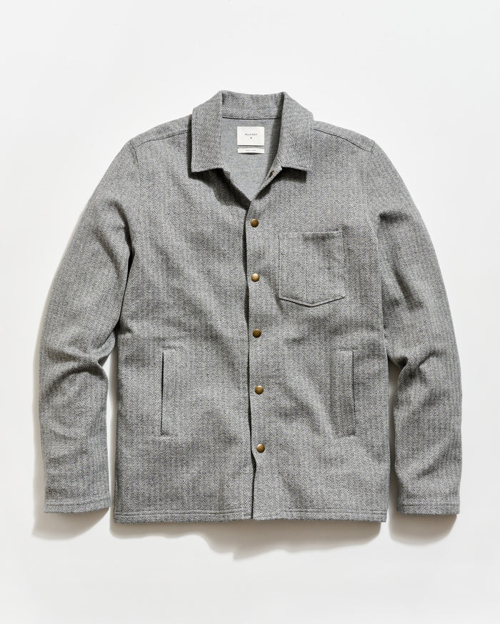 Gray checkered shirt with button details on a white background