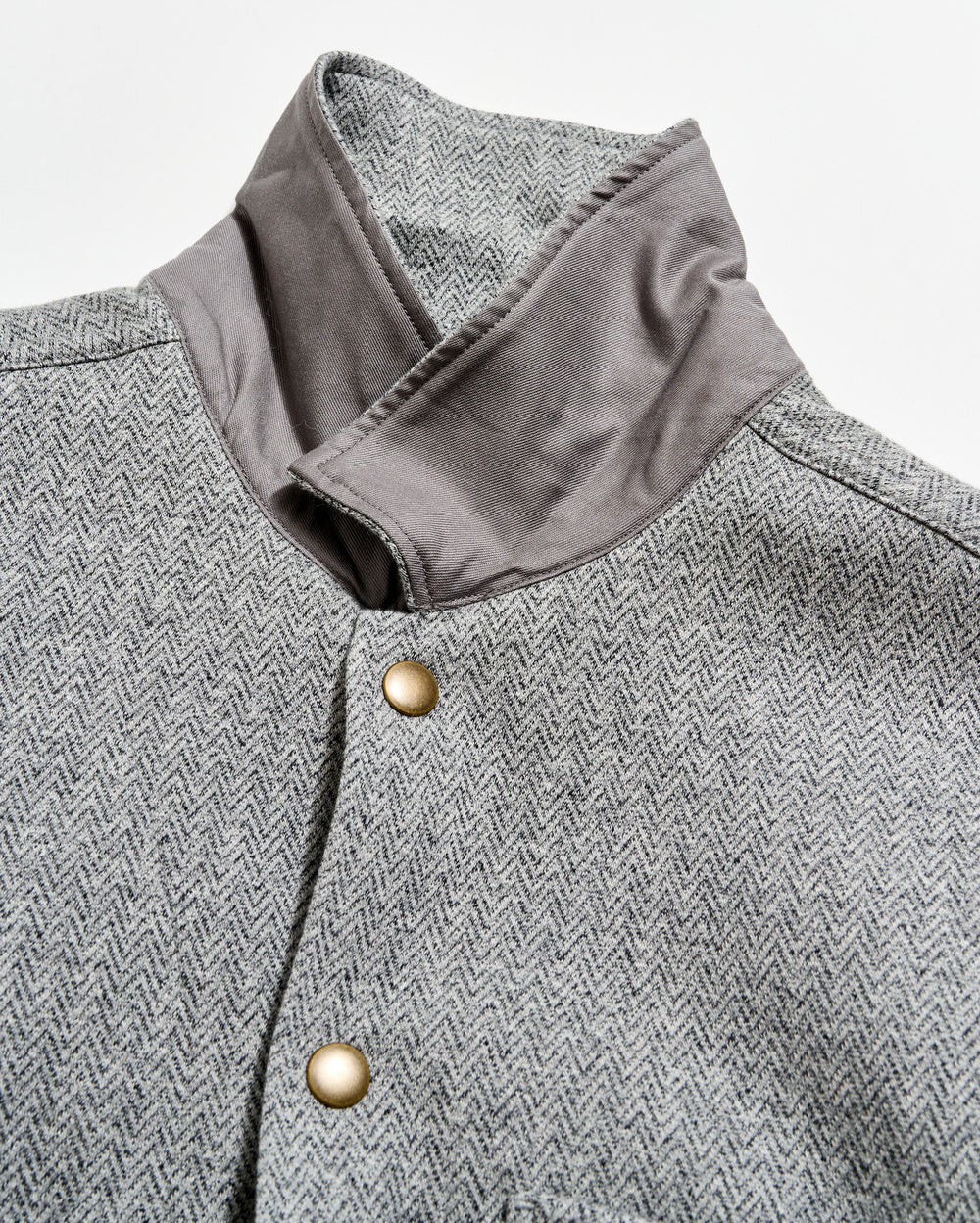 Gray herringbone patterned coat with a close-up of the collar and button details.