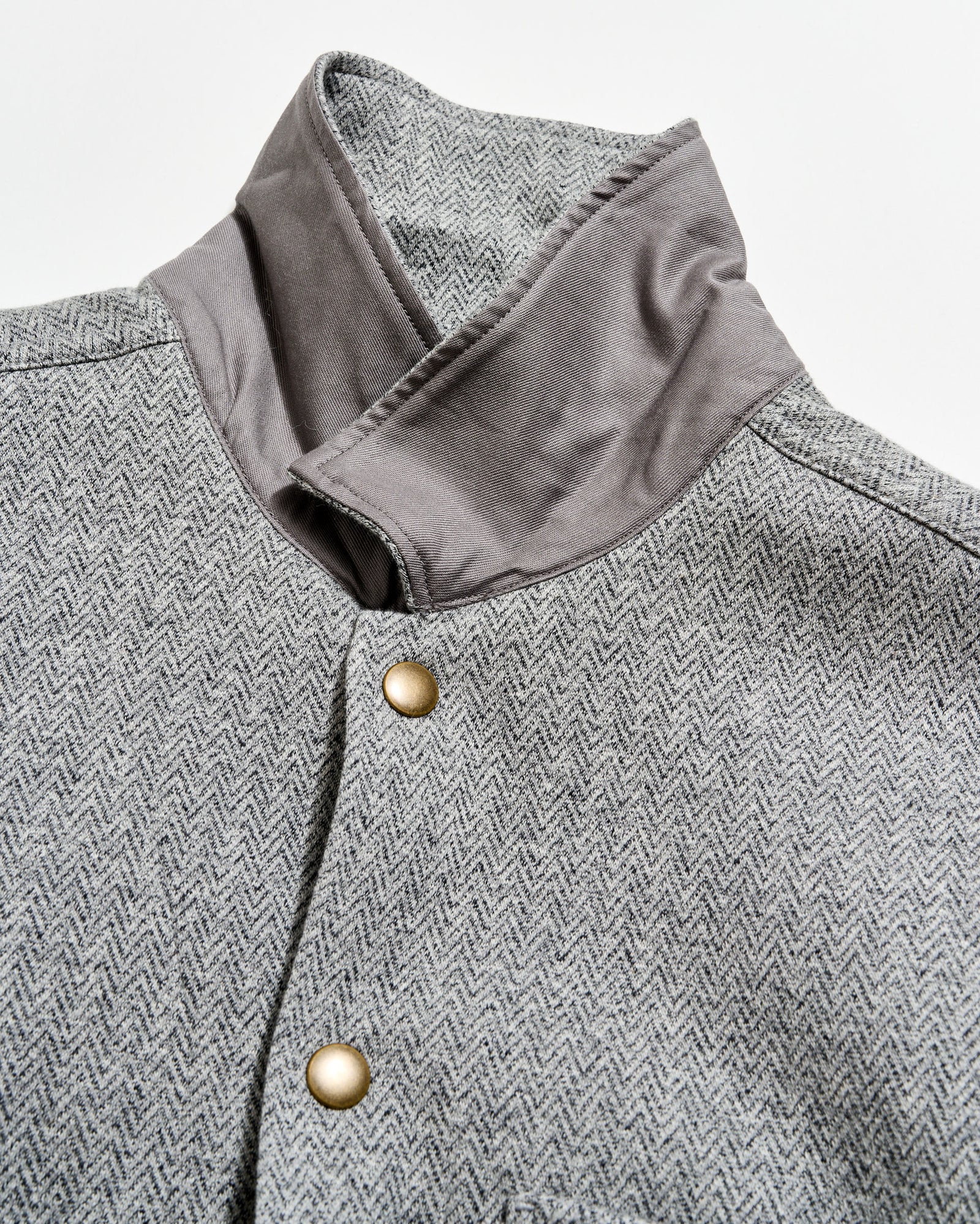 Gray herringbone patterned coat with a close-up of the collar and button details.