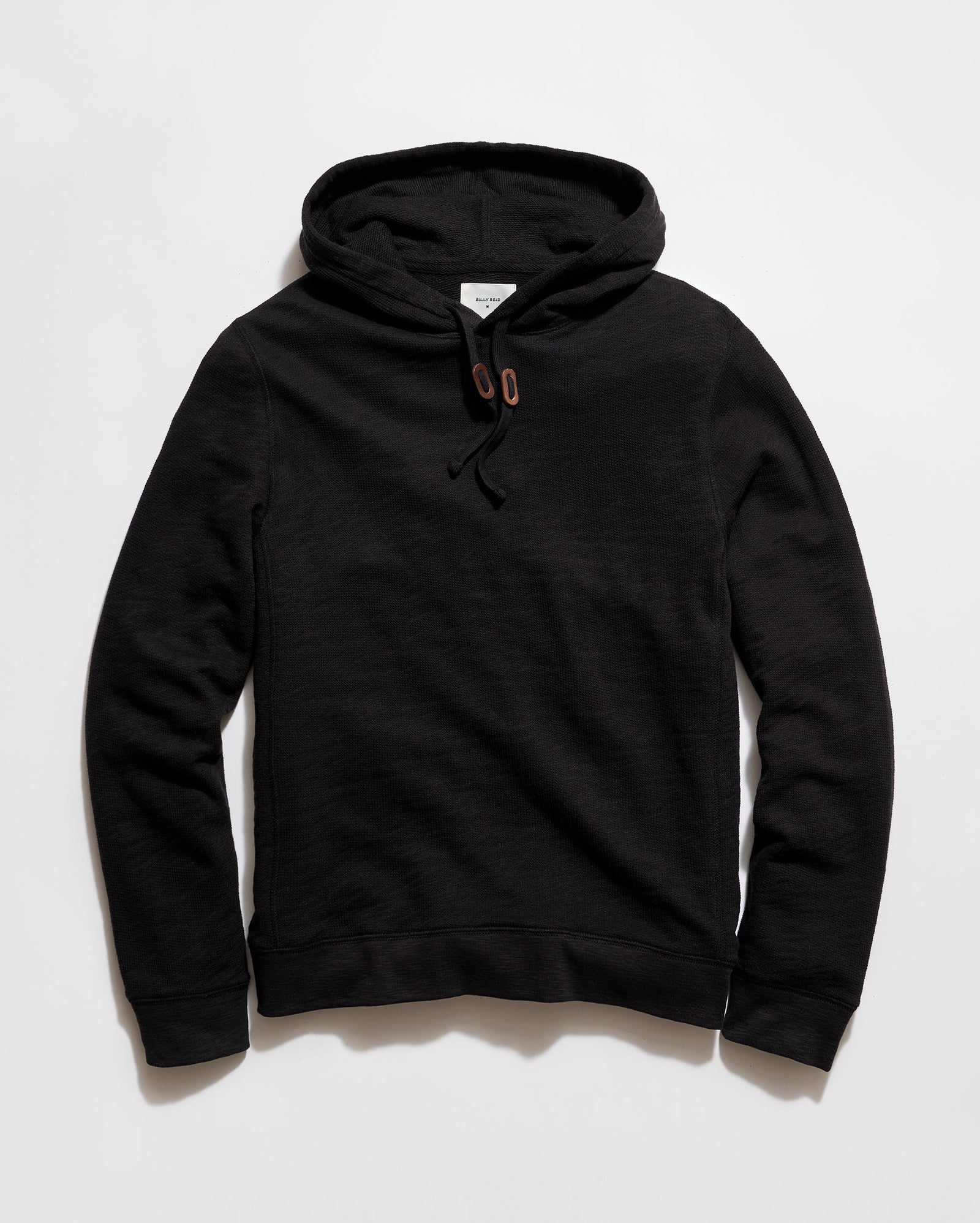 Black hoodie on a light gray background