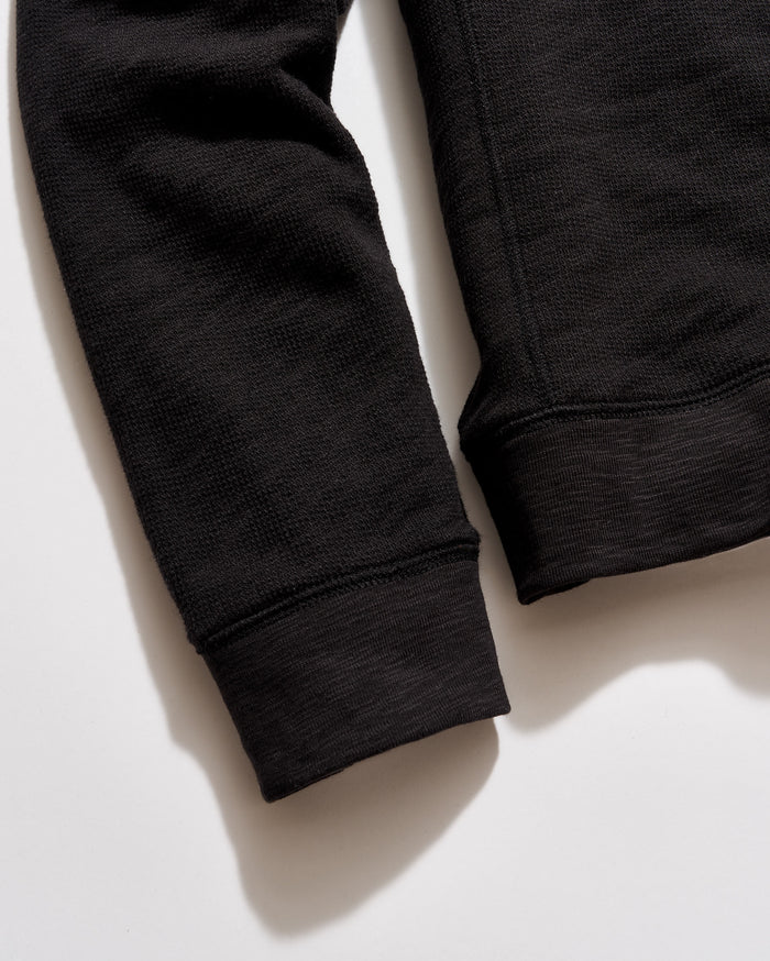 Close-up of black sweatpants on a light background