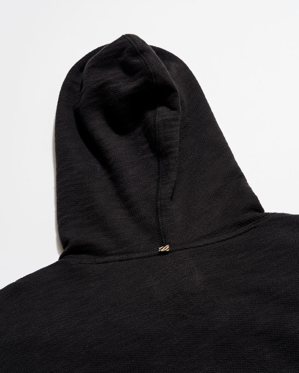 Black hoodie with a hood on a light gray background
