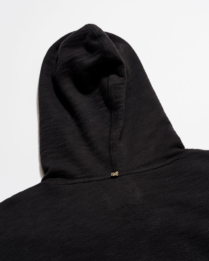 Black hoodie with a hood on a light gray background
